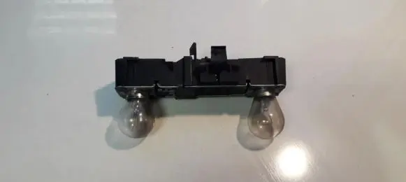 Tail light bulb cover holder