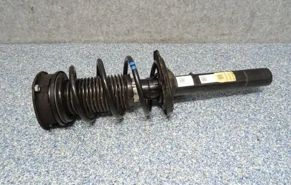 Volkswagen Golf VII Front shock absorber with coil spring 5Q0413023ME