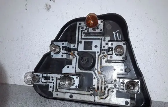 Tail light bulb cover holder