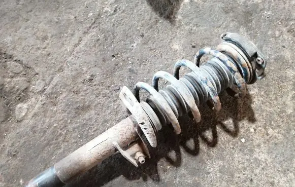Volkswagen Golf V Front shock absorber with coil spring 1K0413031BA