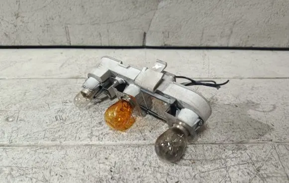 Tail light bulb cover holder