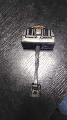 Front door check strap stopper