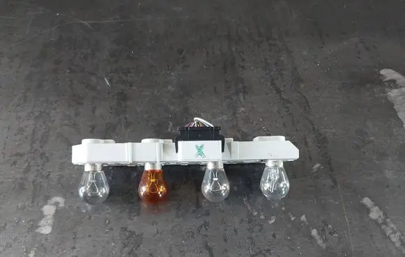 Tail light bulb cover holder