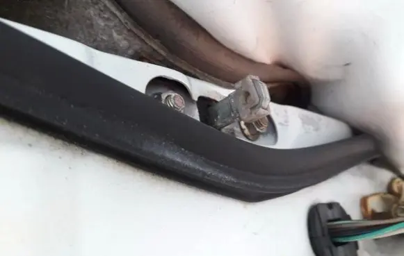 Front door check strap stopper