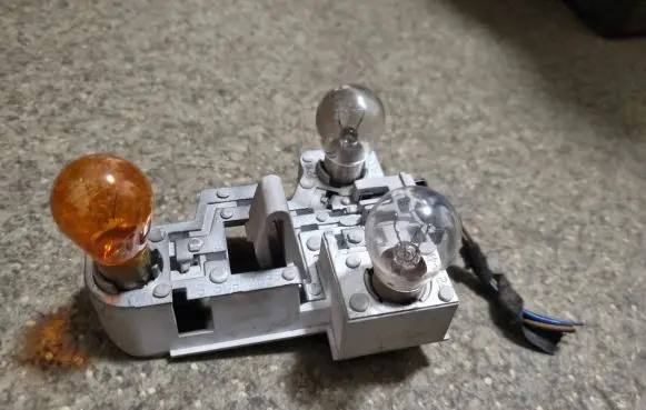 Tail light bulb cover holder