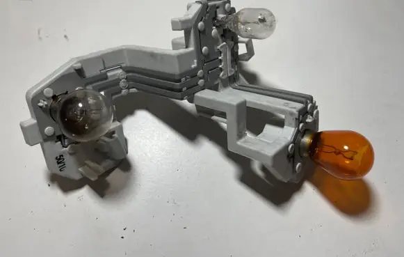 Tail light bulb cover holder