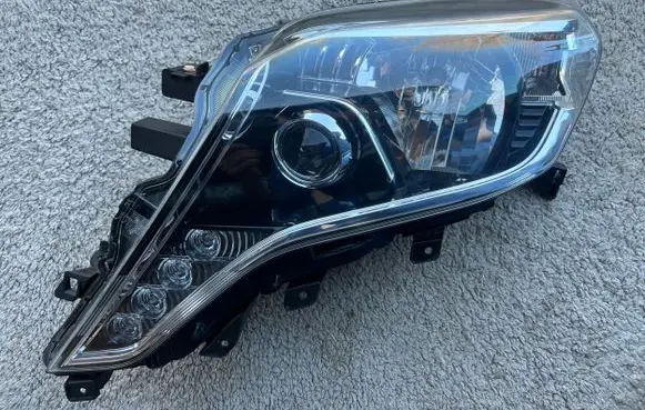 Toyota Land Cruiser (J150) Headlight/headlamp 8114560J20