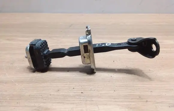 Front door check strap stopper
