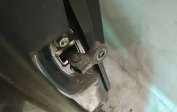 Front door check strap stopper