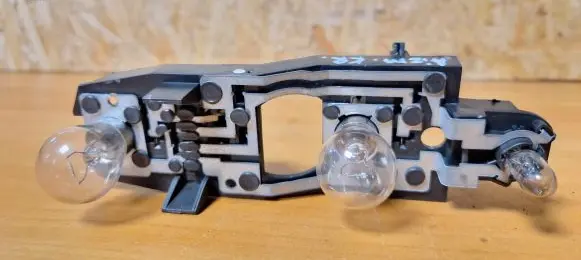 Tail light bulb cover holder