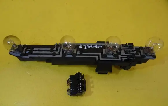 Tail light bulb cover holder