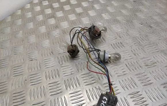 Tail light bulb cover holder