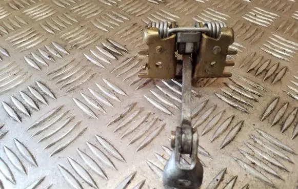 Front door check strap stopper