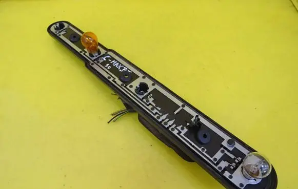 Tail light bulb cover holder