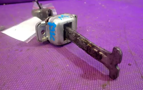 Front door check strap stopper