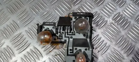 Tail light bulb cover holder