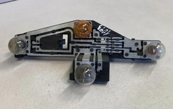 Tail light bulb cover holder