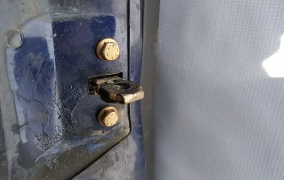 Front door check strap stopper