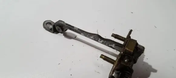 Front door check strap stopper