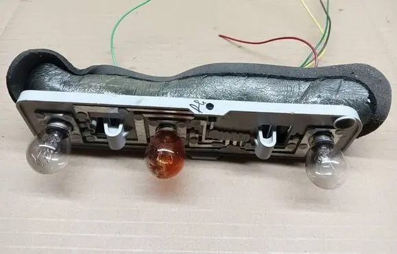 Tail light bulb cover holder
