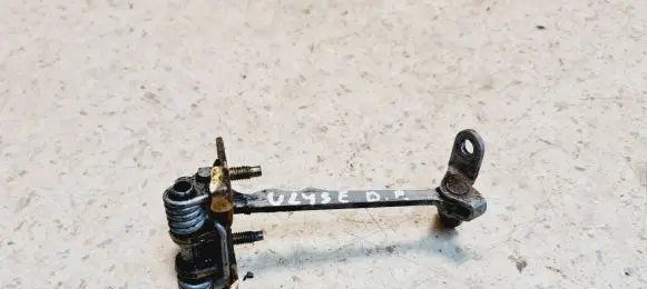 Front door check strap stopper