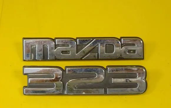 Mazda 323 Manufacturers badge/model letters 