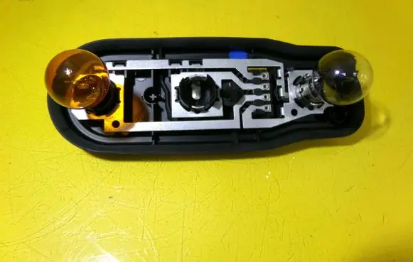Tail light bulb cover holder