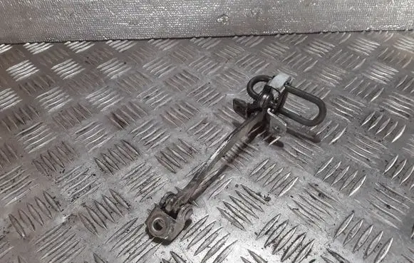 Front door check strap stopper