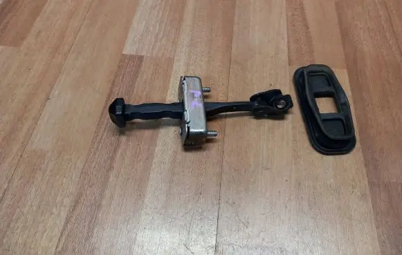 Front door check strap stopper