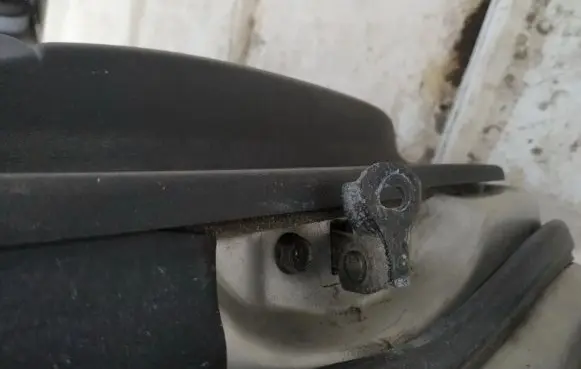 Front door check strap stopper