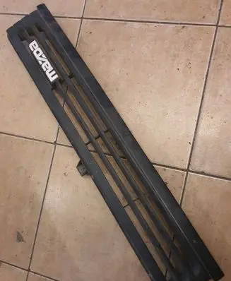 Mazda 626 Front bumper upper radiator grill B30050711 K2443