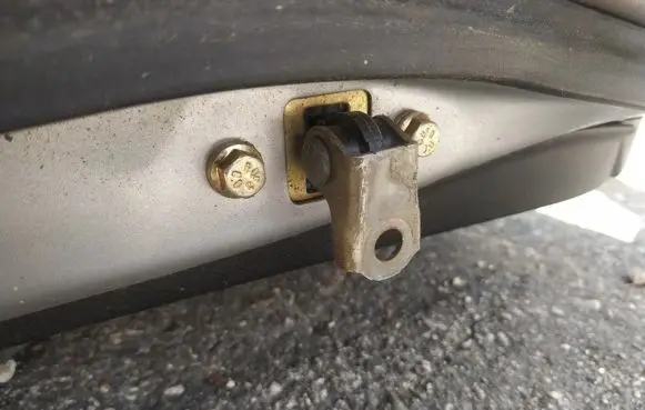 Front door check strap stopper