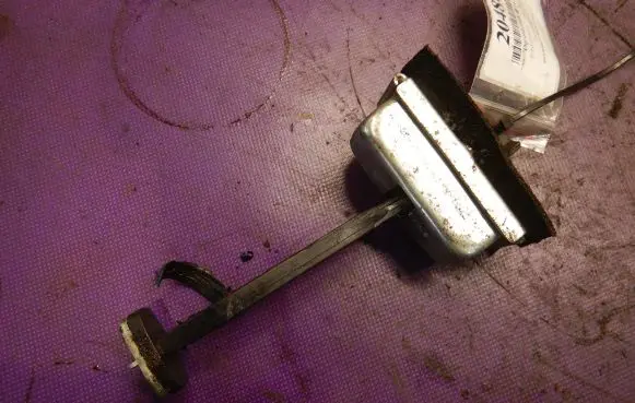 Front door check strap stopper