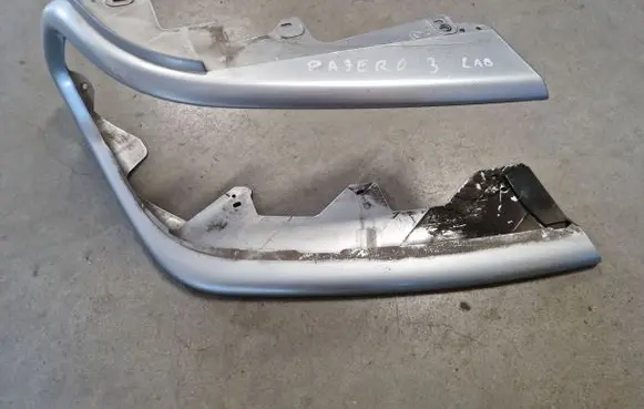 Mitsubishi Pajero Sport I Under headlight/headlamp trim 