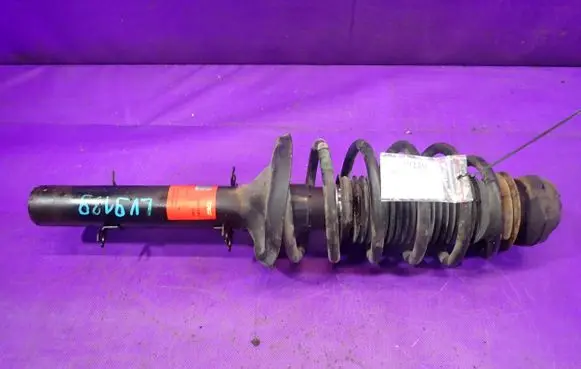 Volkswagen Golf IV Front shock absorber with coil spring JGM209T