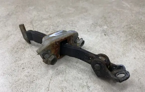 Front door check strap stopper