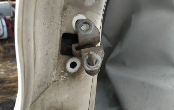 Front door check strap stopper