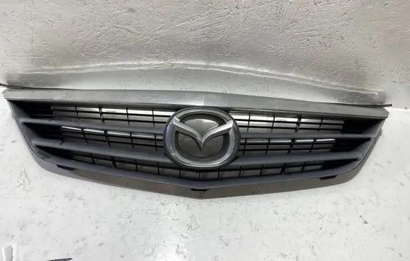 Mazda 626 Front bumper upper radiator grill GG2M50712