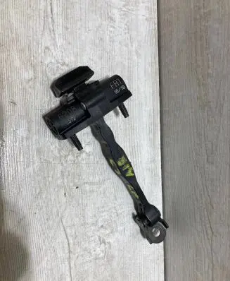 Front door check strap stopper