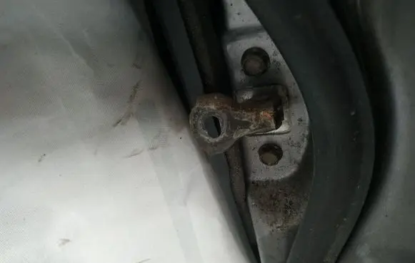 Front door check strap stopper