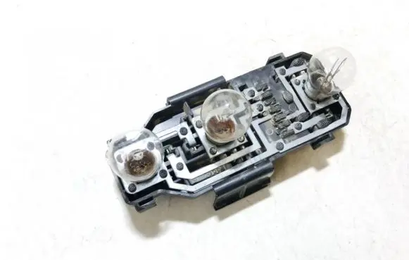 Tail light bulb cover holder