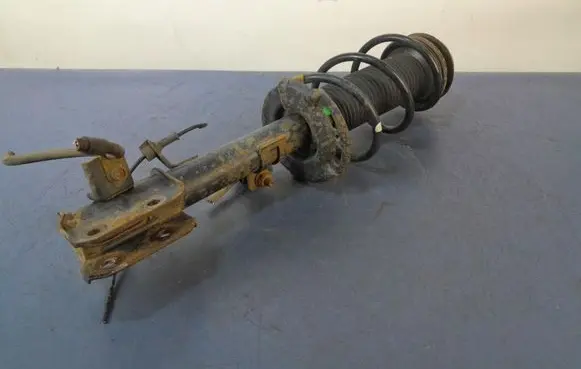Suzuki Swift I Front shock absorber with coil spring