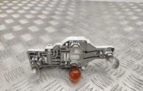 Tail light bulb cover holder