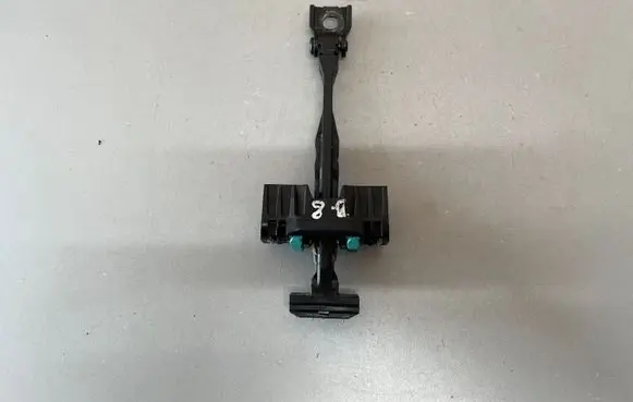 Front door check strap stopper