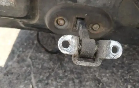 Front door check strap stopper