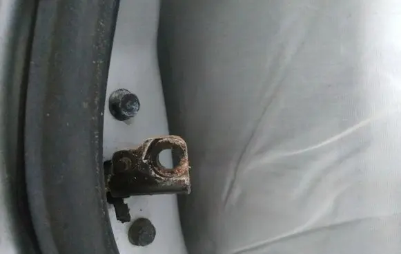 Front door check strap stopper