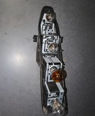 Tail light bulb cover holder
