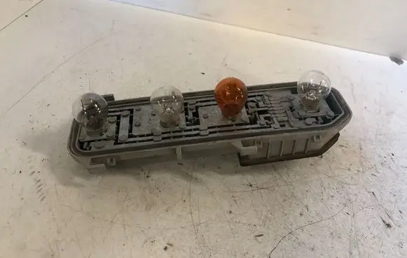 Tail light bulb cover holder