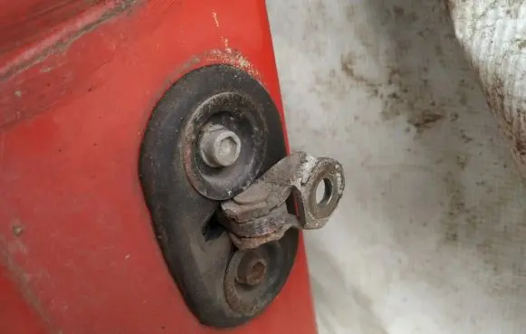 Front door check strap stopper