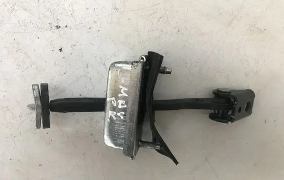 Front door check strap stopper